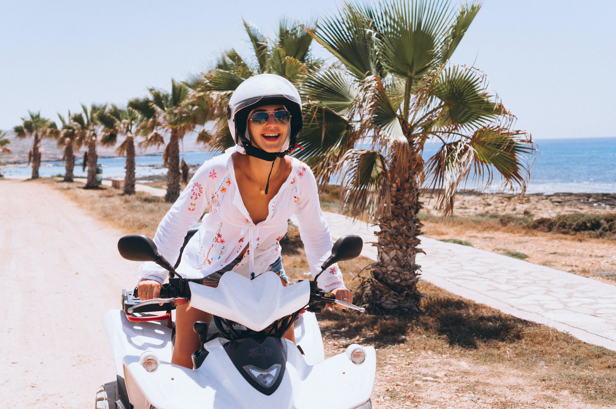 Woman on an ATV by the ocean