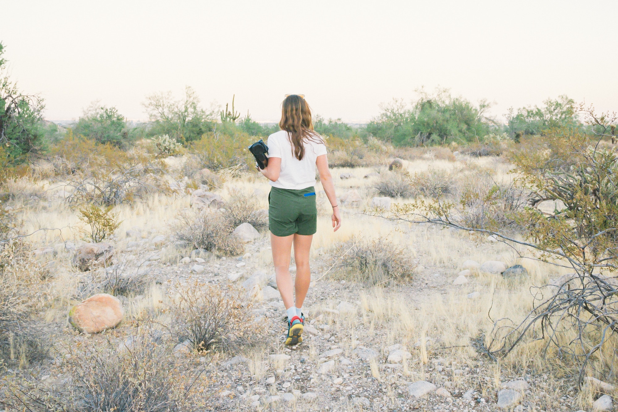 A woman walking through the desert landscape