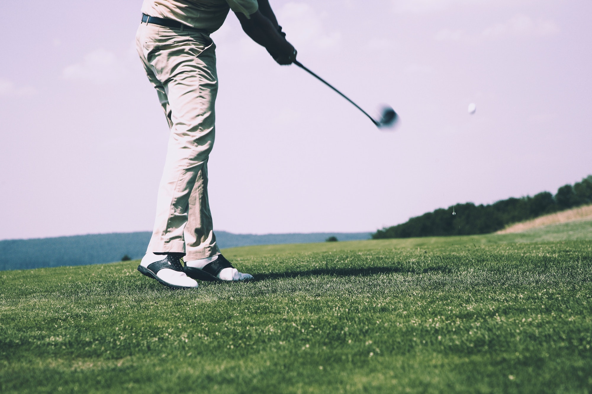 Photo of a person hitting a golf ball