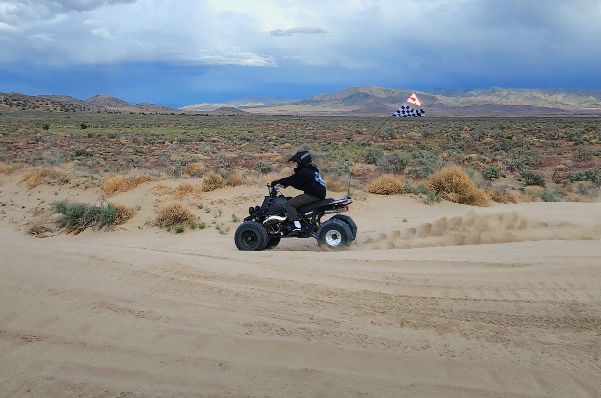 A person in an ATV through the dunes