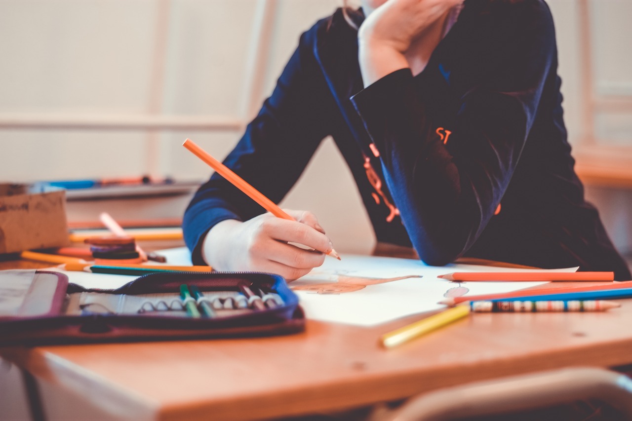 student writing on desk